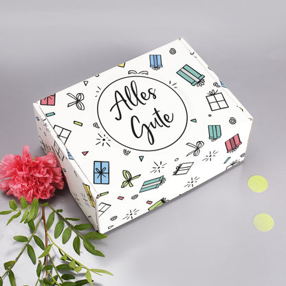 Geschenkverpackung „Alles Gute“ – Ansicht von oben mit Blume und Deko