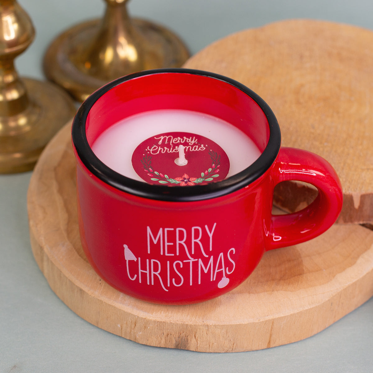Rote Dolomitetasse mit weißem Merry-Christmas-Schriftzug als Kerze