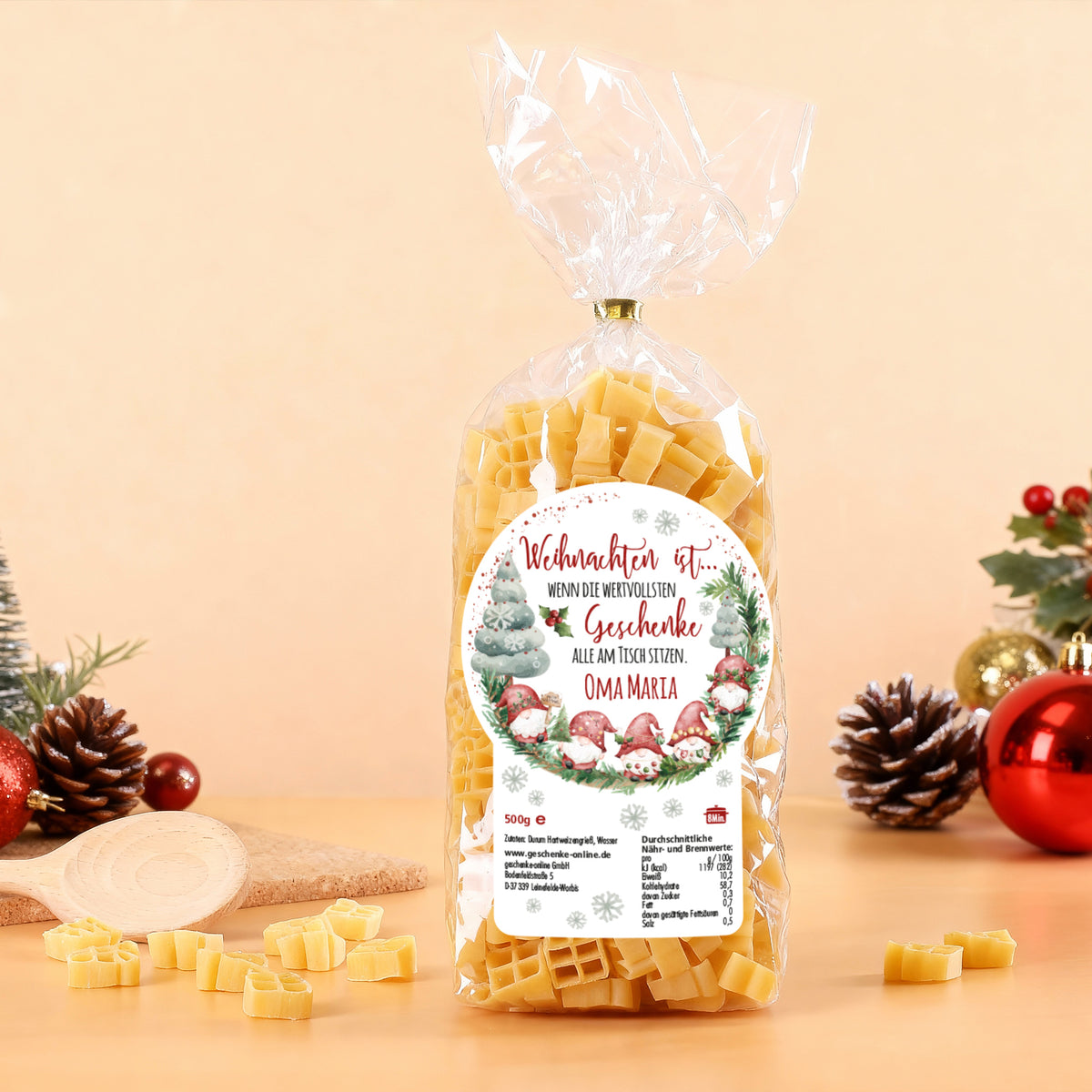 Packung bunter Geschenk-Nudeln mit personalisiertem Namen „Oma Maria“ vor festlicher Dekoration