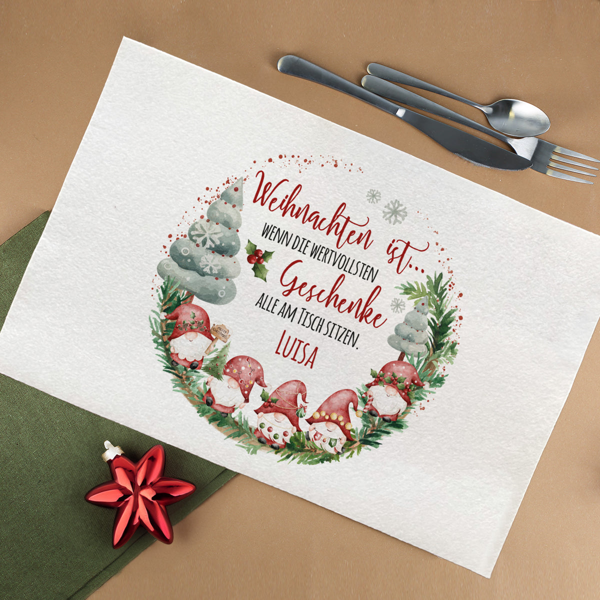 Weihnachtliches Platzdeckchen aus Filz mit Wichtelmotiv und personalisiertem Namen, dekoriert mit Besteck und rotem Sternanhänger, festlich gedeckter Tisch.