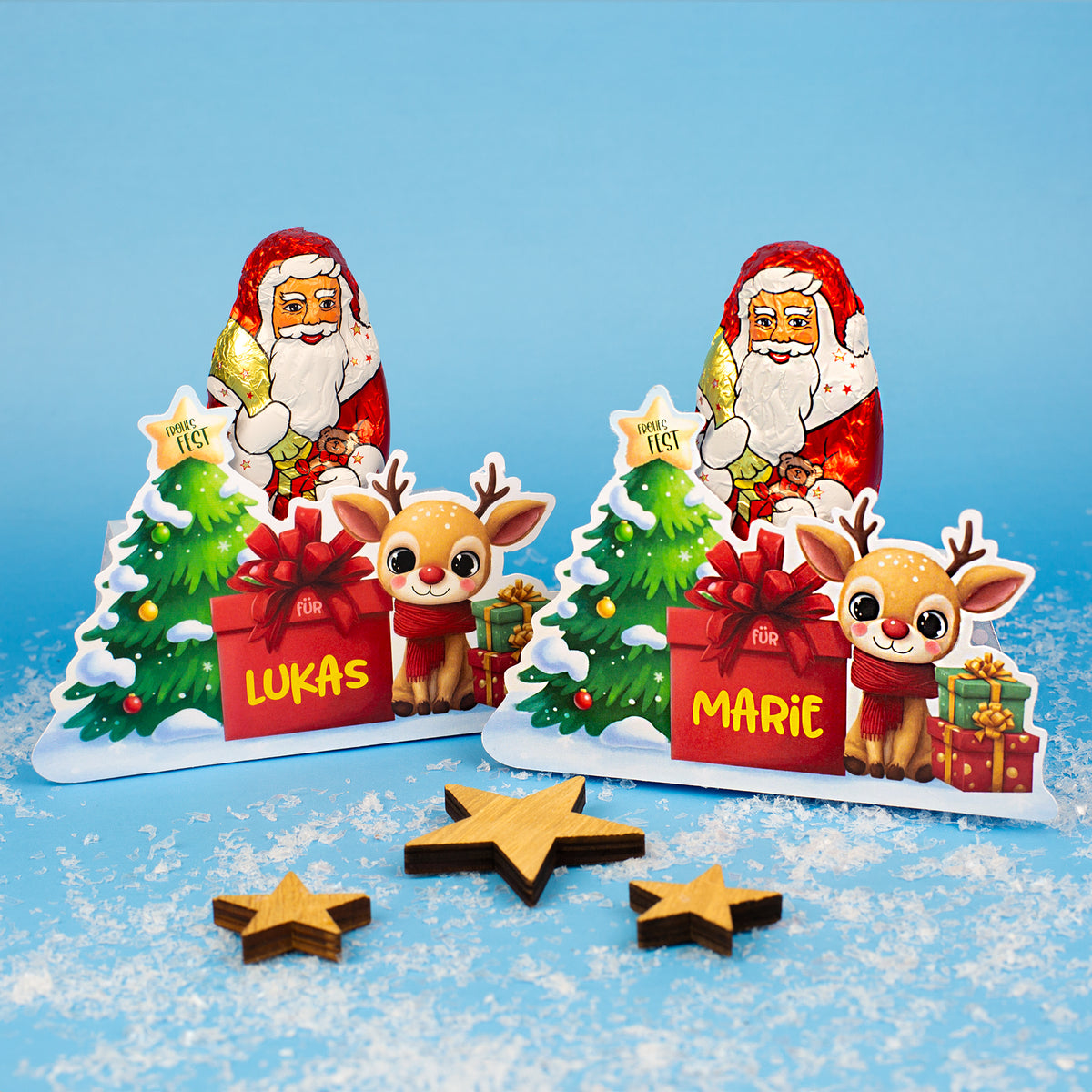 Set aus zwei personalisierten Lindt Weihnachtsmann-Verpackungen mit den Namen Lukas und Marie im Schneelook