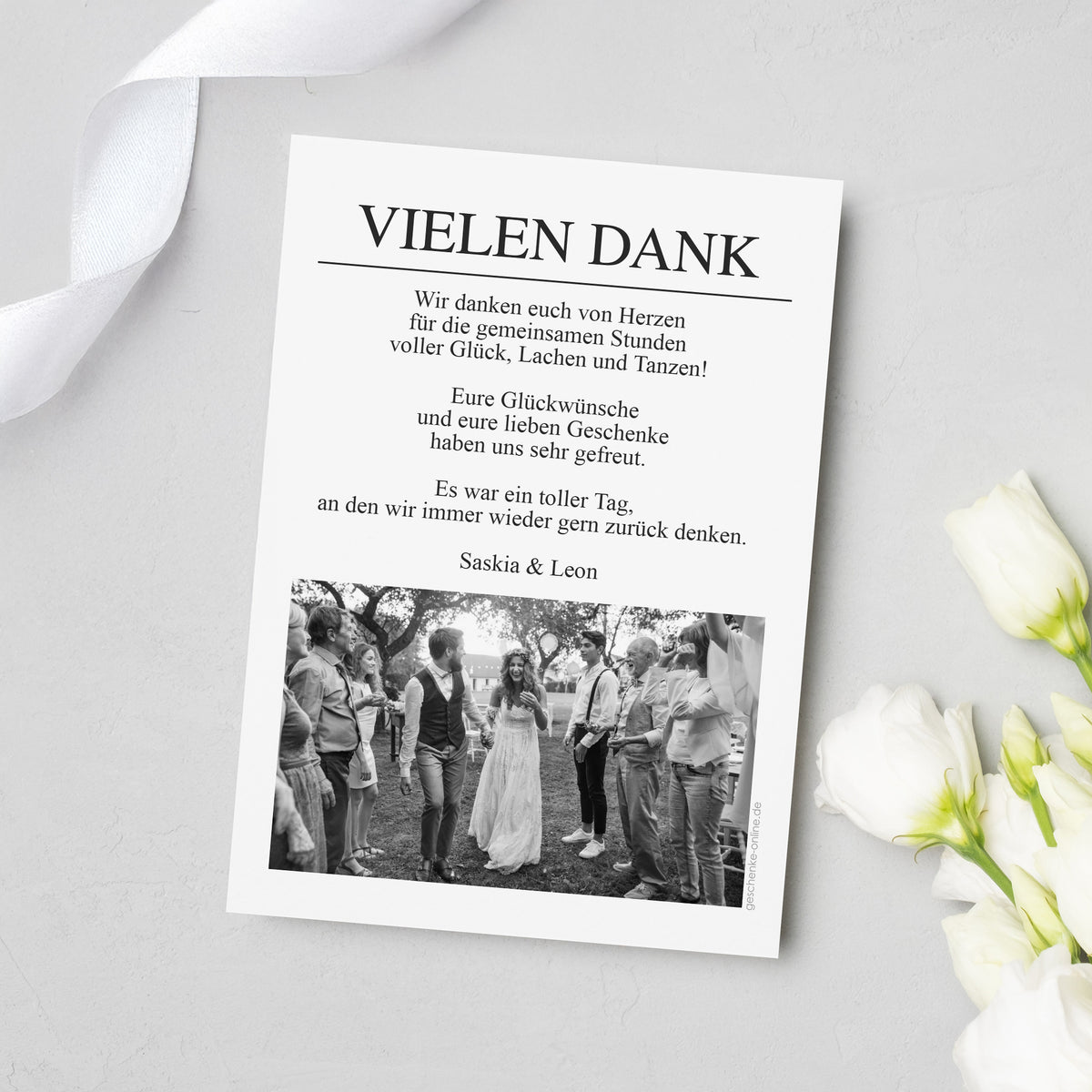 Rückseite der Hochzeits-Danksagungskarte im Zeitungsdesign mit Überschrift „VIELEN DANK“, persönlichem Dankestext und Foto in Schwarzweiß am unteren Rand